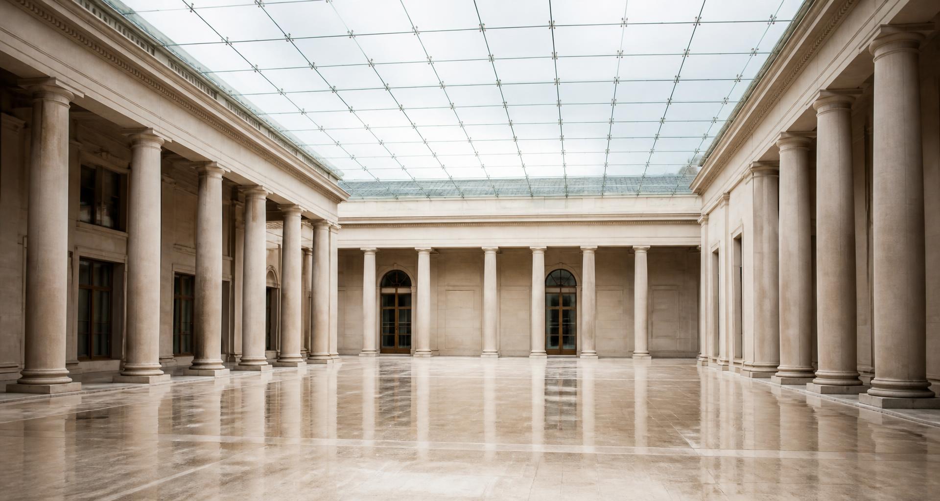 Grand columned courtyard beneath a modern glass roof